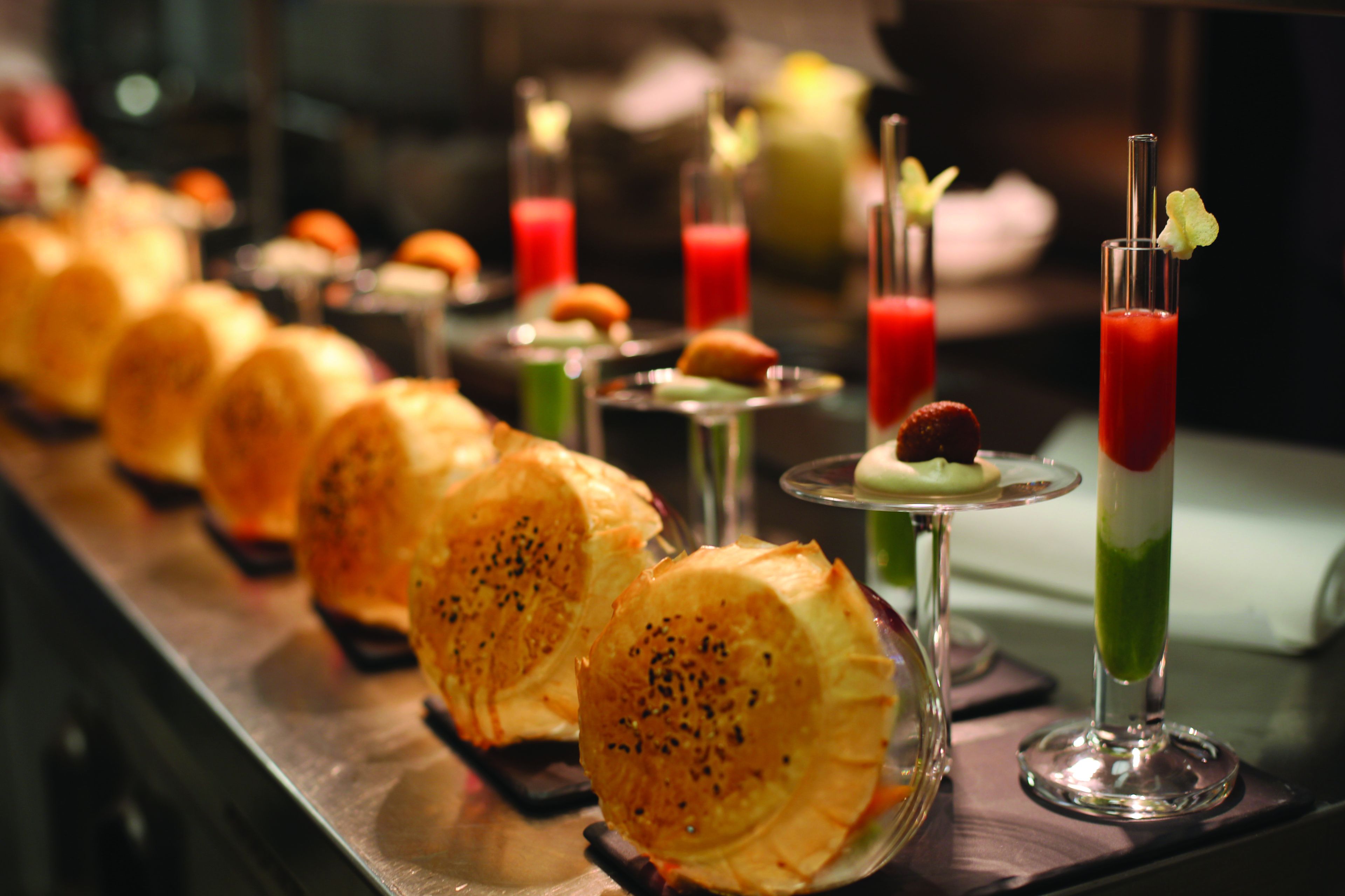 A buffet with various dishes and drinks.