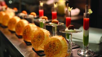 A buffet with various dishes and drinks.