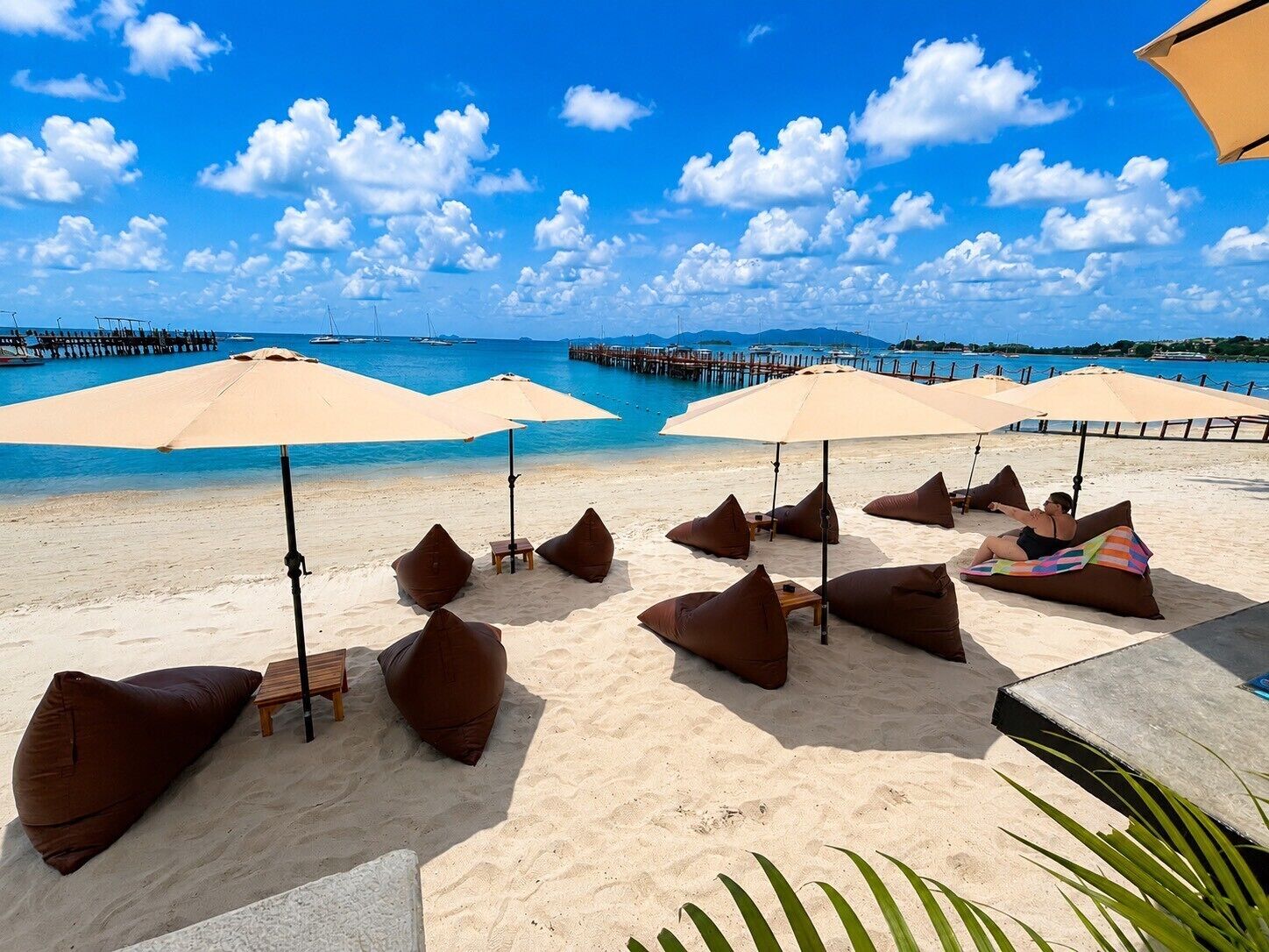On the beach, white sand, sun-loungers, beach umbrellas