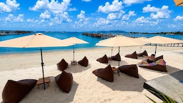 On the beach, white sand, sun-loungers, beach umbrellas