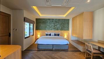 Une chambre d’hôtel moderne avec un grand lit, des tables de chevet, un bureau et une fenêtre.