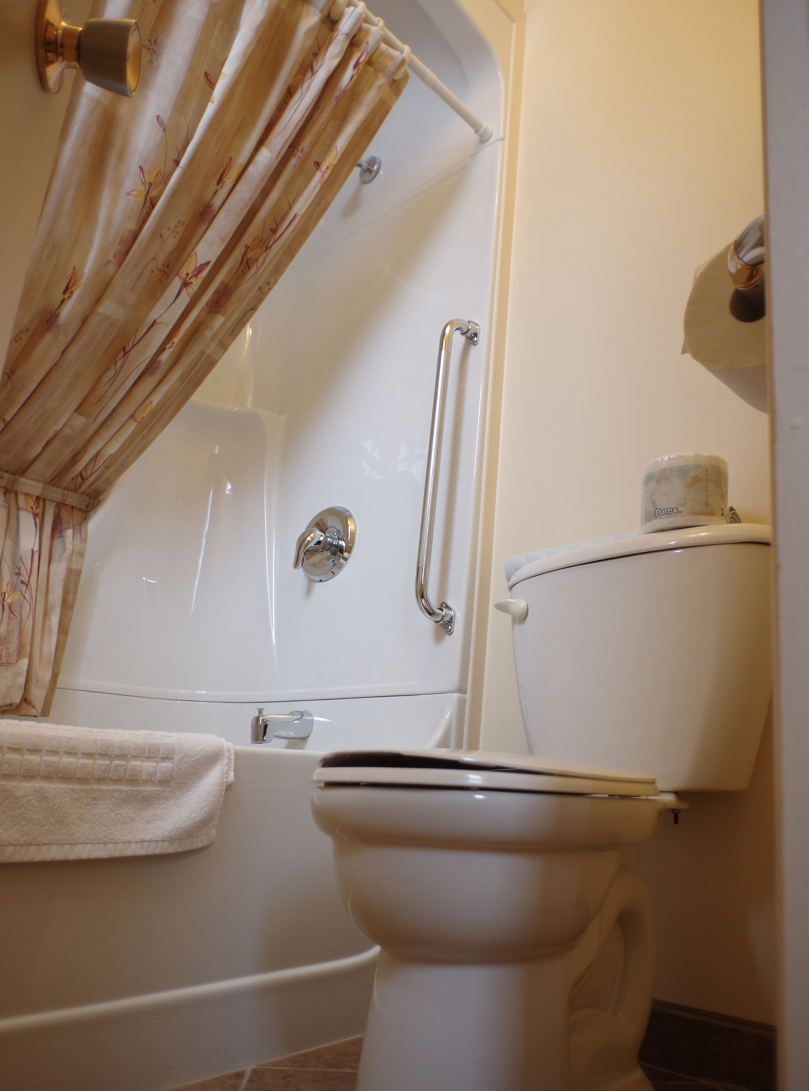 Une salle de bain avec une baignoire, des toilettes et un rideau de douche.
