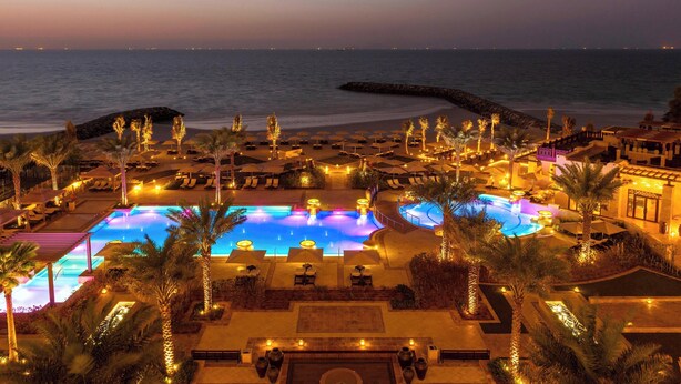 A resort pool area with multiple pools, palm trees, and beach views. - Ajman Saray, a Luxury Collection Resort, Ajman (Ajman)
