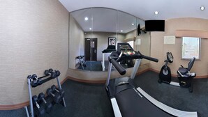 A gym with a treadmill, dumbbells, and an elliptical machine. - Americas Best Value Inn & Suites Cuero (Cuero)