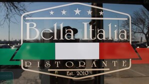 A restaurant sign with the name "Bella Italia Ristorante" and the establishment year "Est. 2010". - Wyatt Earp Hotel (Dodge City)