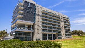 A multi-story hotel with a prominent anchor logo, large windows, and a modern architectural design. - West All Suite Boutique Ashdod (Ashdod)