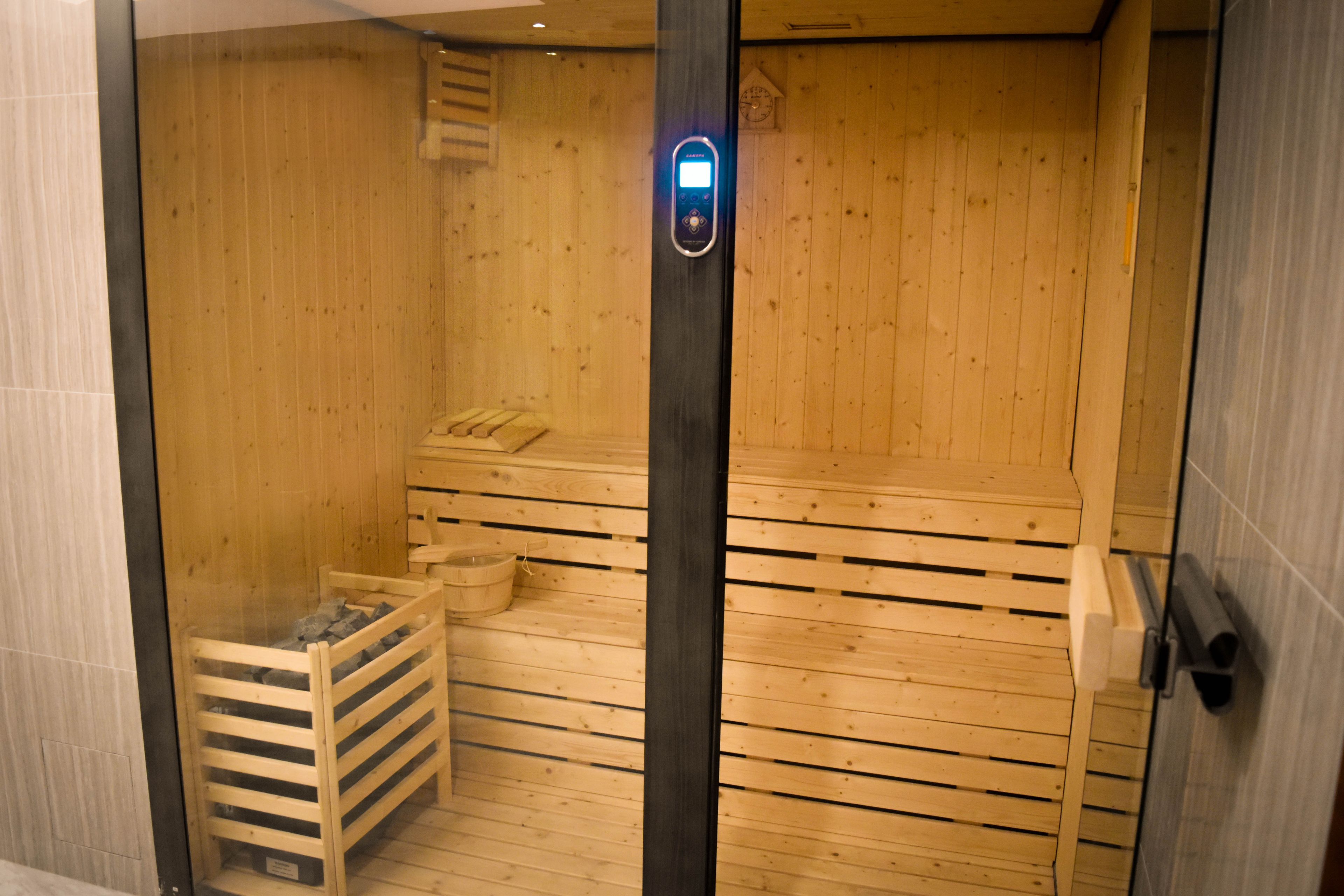A sauna with wooden walls and a bench.