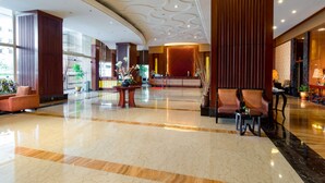 A spacious lobby with a polished marble floor, a reception desk, seating areas, and large windows allowing natural light. - Best Western Green Hill Hotel (Yangon)