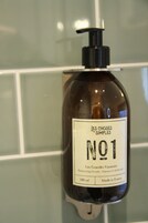 A bottle of shampoo with a pump dispenser, labeled 'NO1' and 'Made in France'.