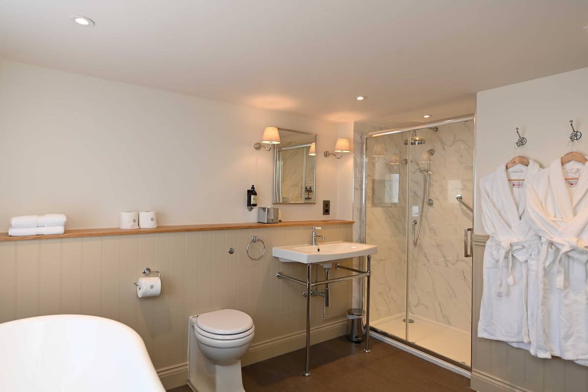 deluxe suite room | bathroom | hair dryer, towels, soap, shampoo