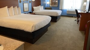 A hotel room with two beds, a desk, a chair, and a window with curtains. - Wingate by Wyndham Mount Vernon (Mount Vernon)