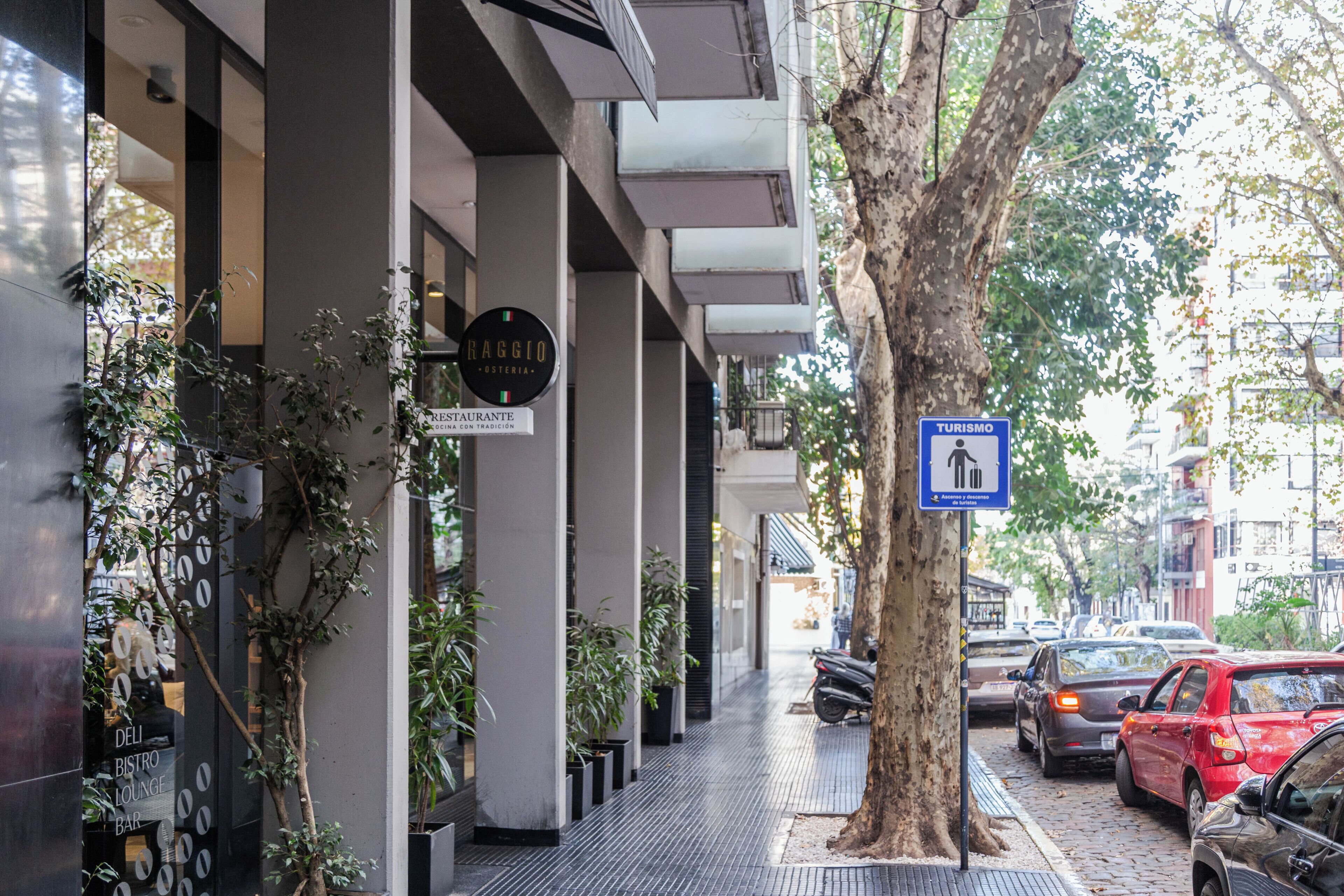 Un carrer amb un restaurant anomenat 'RESTAURANTE DEL BISTRO LOUNGE BAR' i un senyalitzador de 'TURISMO'.