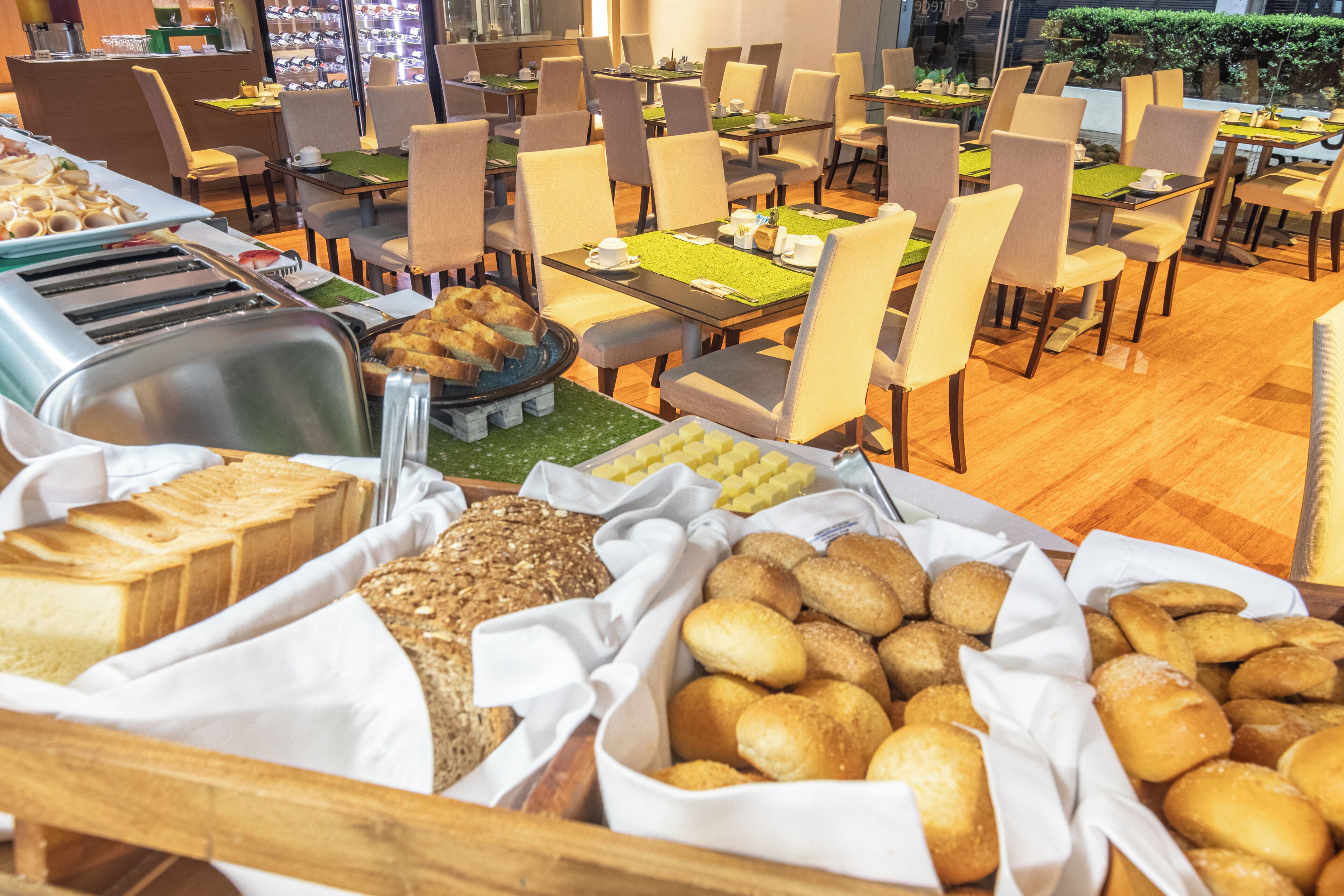 A buffet area with various breads and pastries.