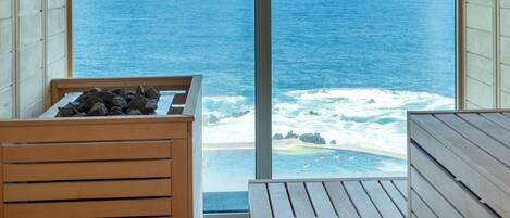 A wooden deck with a view of the ocean.