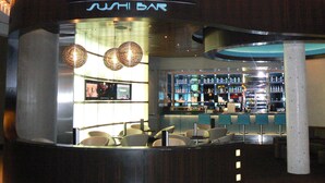 A sushi bar named 'PEARL' with a modern interior, seating area, and bar counter.