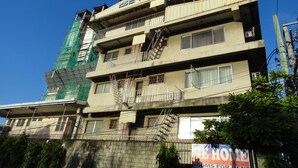 A multi-story building with a sign reading "GE HOME" indicating it is a residential property. - GE Home Residential Inn (Cebu City)
