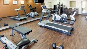 A gym with treadmills, elliptical machines, and weight benches. - Comfort Suites Cotulla near I-35 (Cotulla)