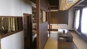 A traditional Japanese room with tatami flooring, sliding doors, and a low table. - SEVEN VILLAGE Motobu (Motobu)