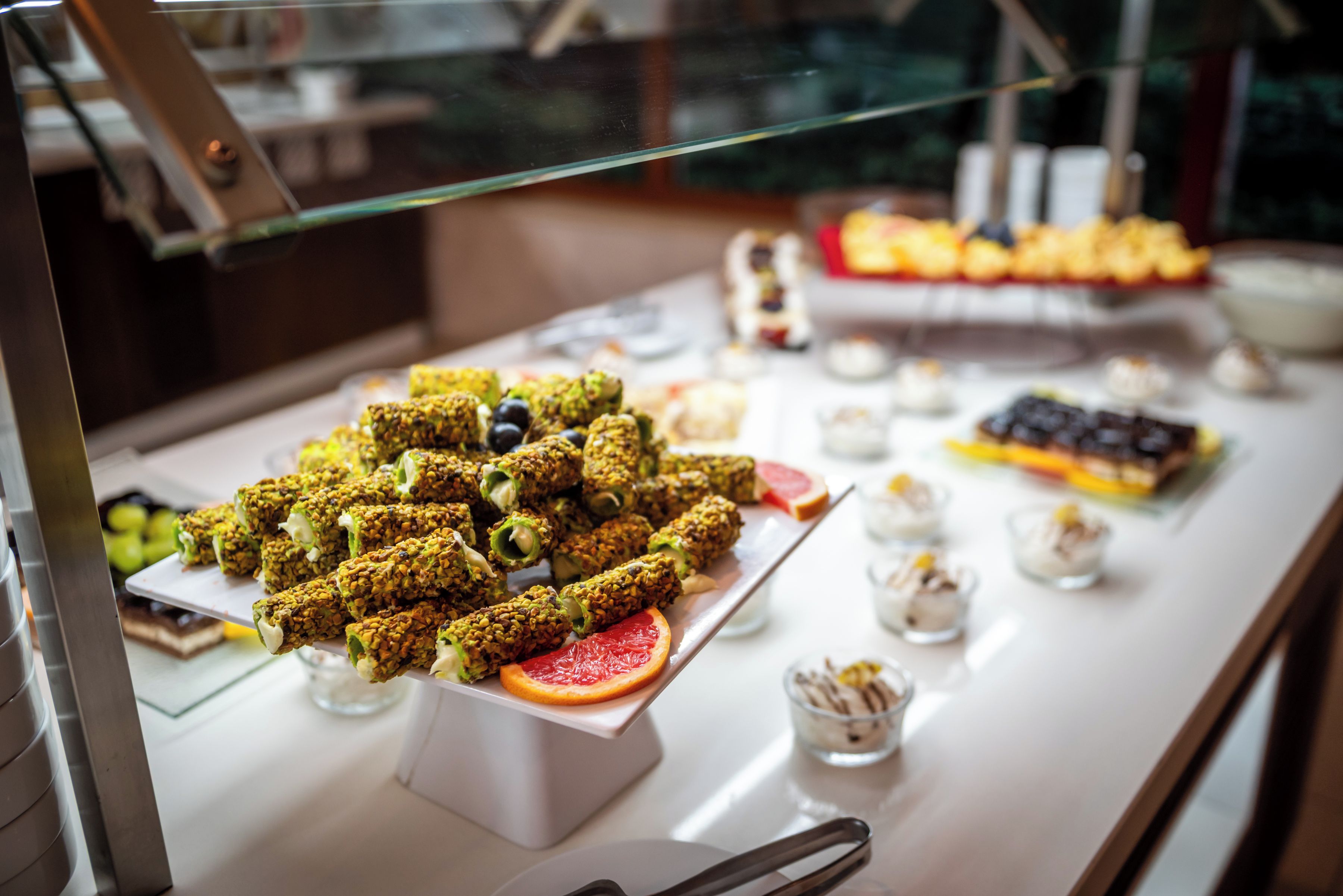 A buffet with various food items, including a selection of pastries and desserts.