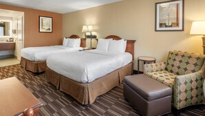 A hotel room with two beds, a chair, a table, and a small round table with lamps. - Best Western Desert Winds (Mojave)