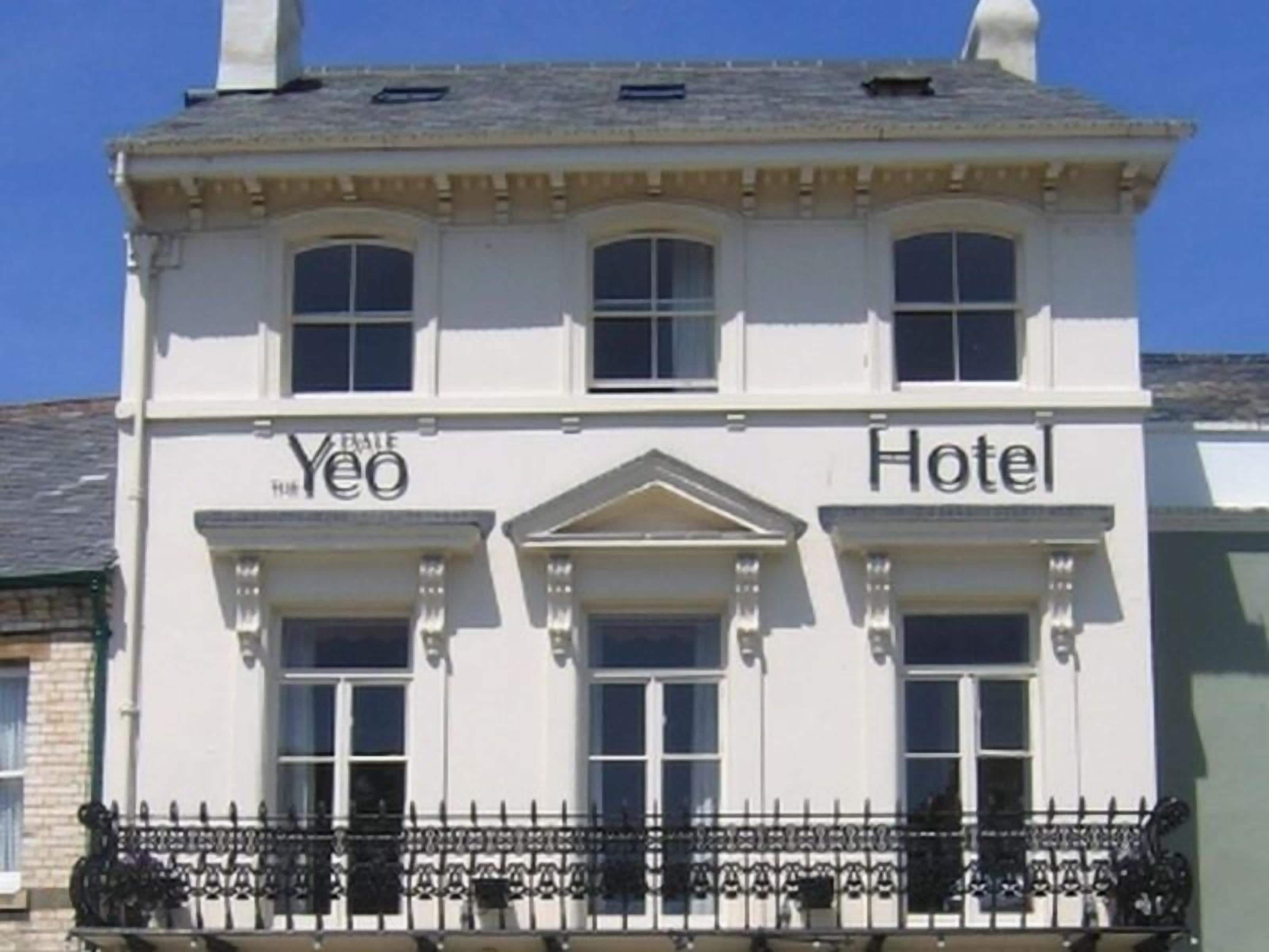 A white building with a balcony and the words "Yeo Hotel" on the facade.
