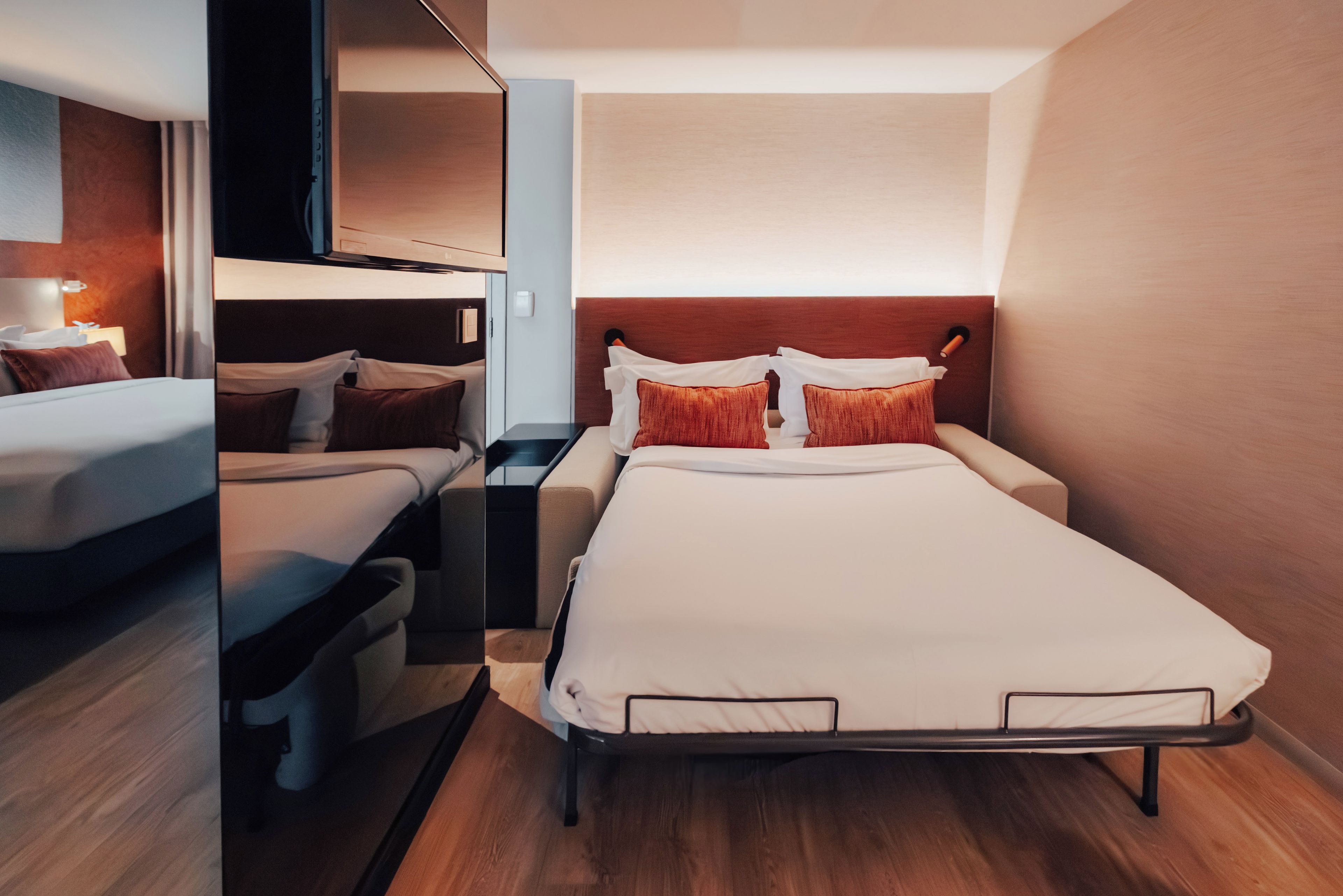 Habitación pequeña con una cama nido, una cama individual y un escritorio.