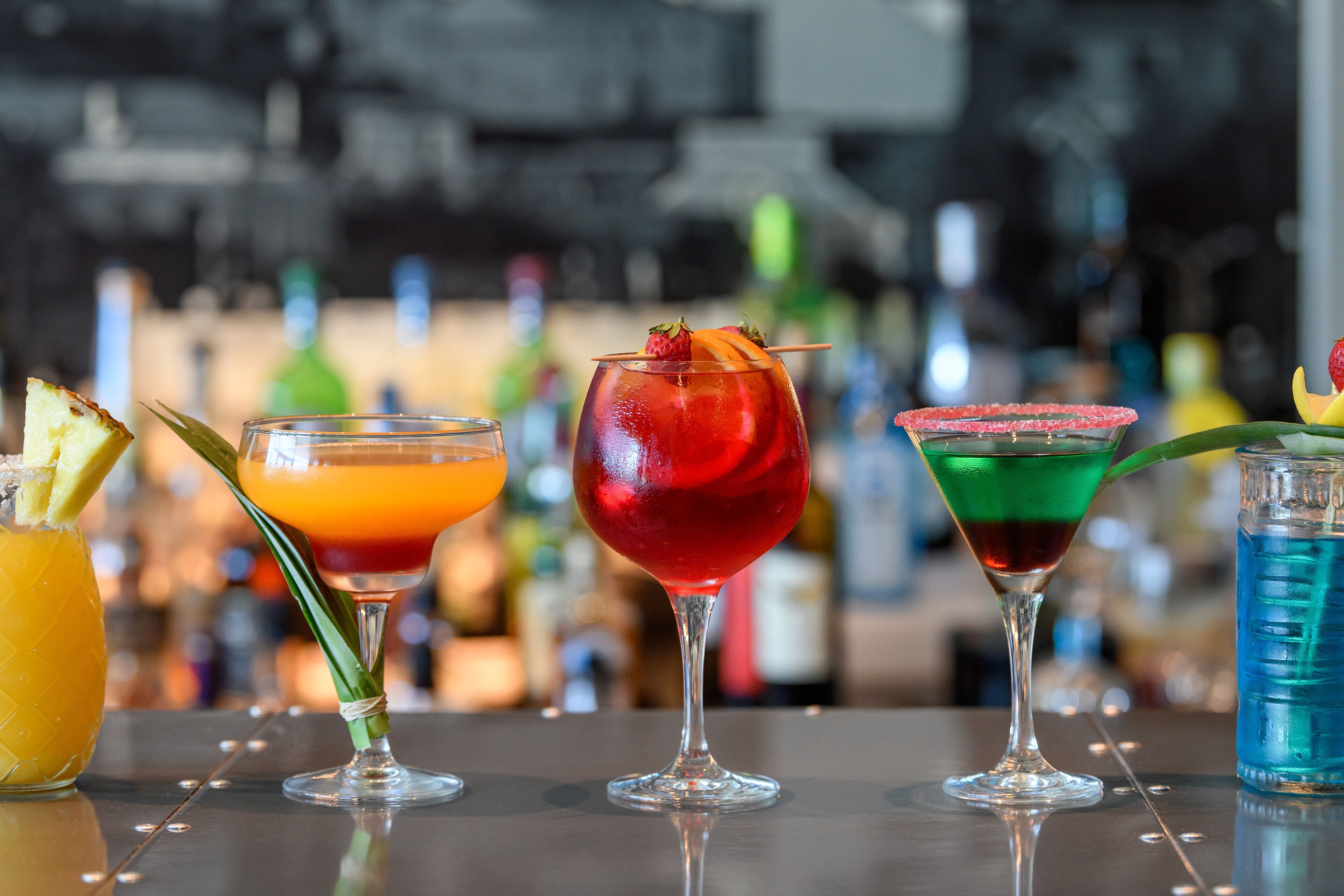 A bar with various colorful cocktails.