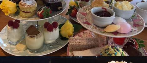 A variety of desserts and pastries on a table, including cakes and scones.