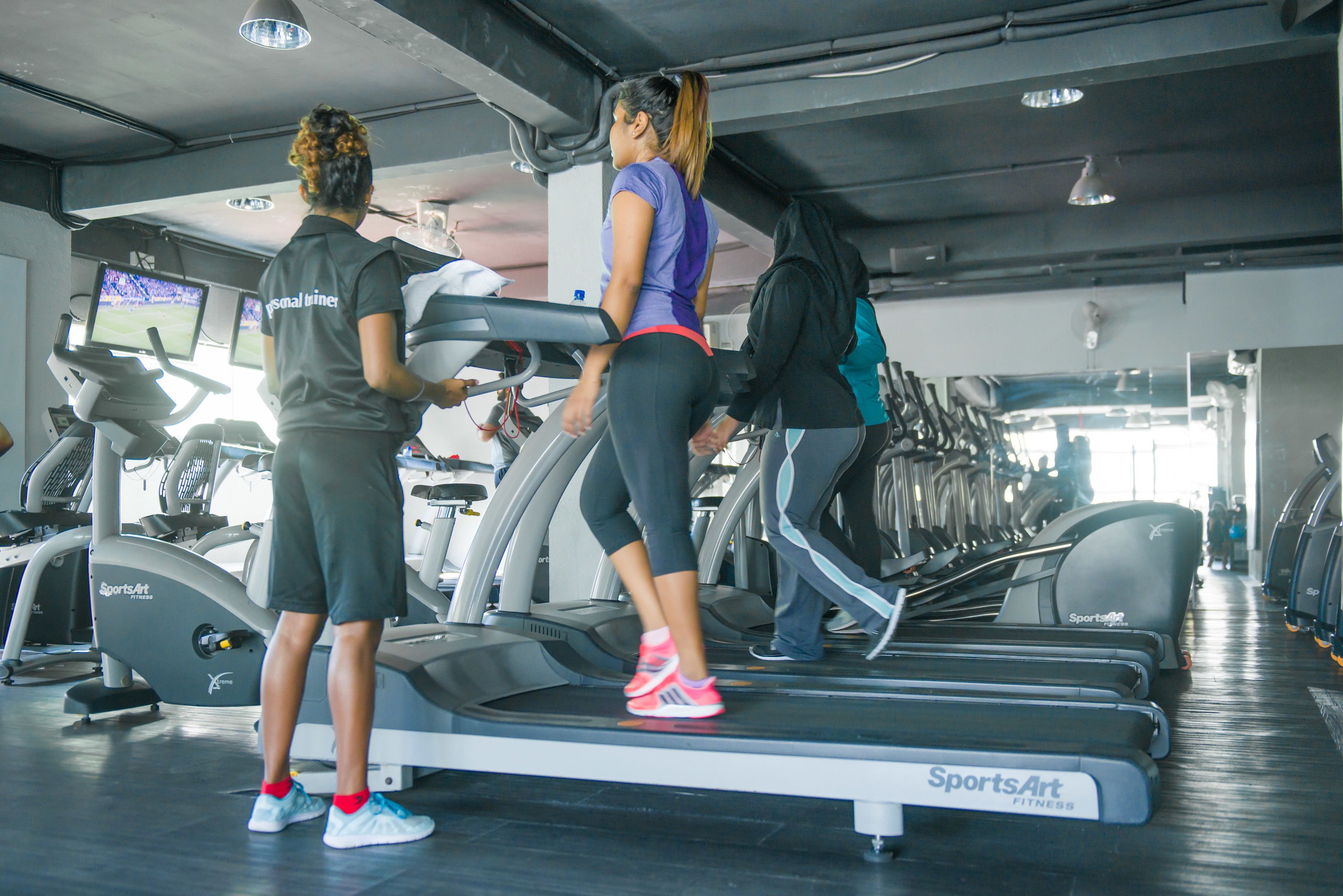 A gym with treadmills, stationary bikes, and weight machines.