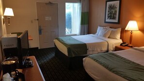 A hotel room with a bed, a desk with a computer, a telephone, and a window with curtains. - Days Inn by Wyndham Chattanooga/Hamilton Place (Chattanooga)