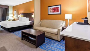 A hotel room with a bed, a sofa, a desk, and a coffee table. - Best Western St. Louis Airport North Hotel & Suites (Hazelwood)