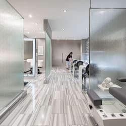 Guests enter a sleek lobby with a polished floor and modern seating area.