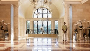 A spacious lobby with a high ceiling, large windows, and a reflective floor. - Four Seasons Resort Orlando at WALT DISNEY WORLD® Resort (Lake Buena Vista)
