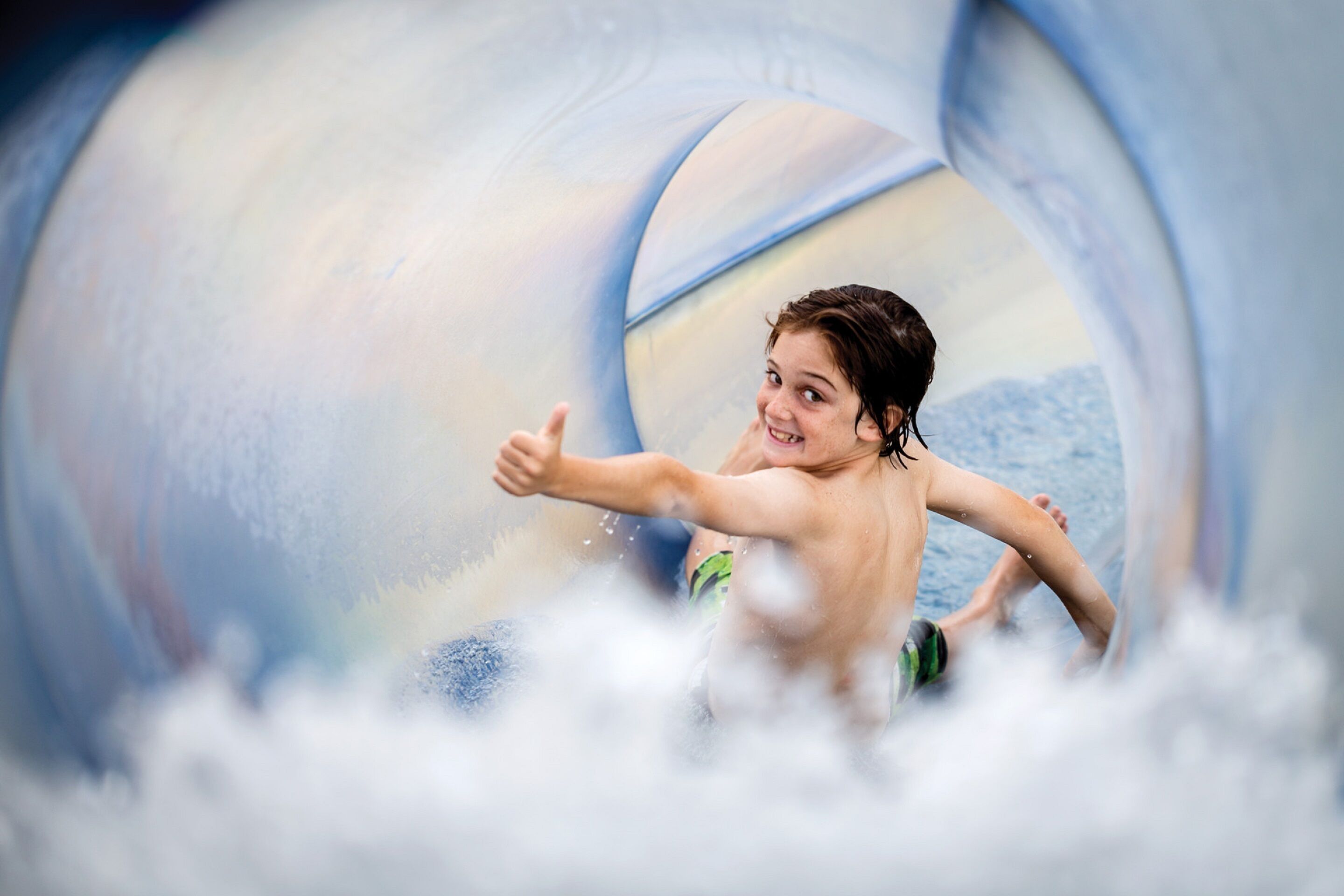 A person sliding down a water slide.