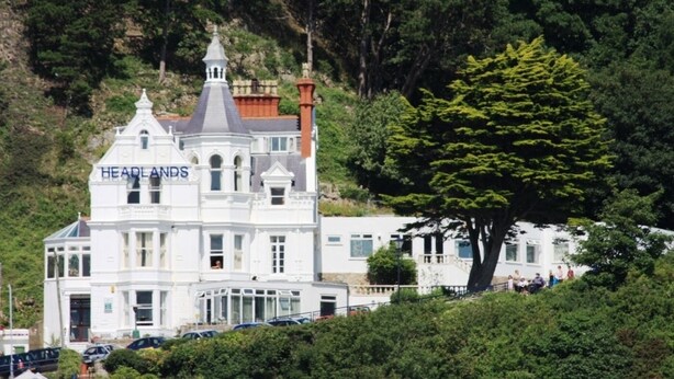 A large white building with a sign reading "HEADLANDS" on the facade. - Headlands Hotel (Llandudno)