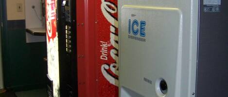A vending machine with a Coca-Cola logo and an ice dispenser.