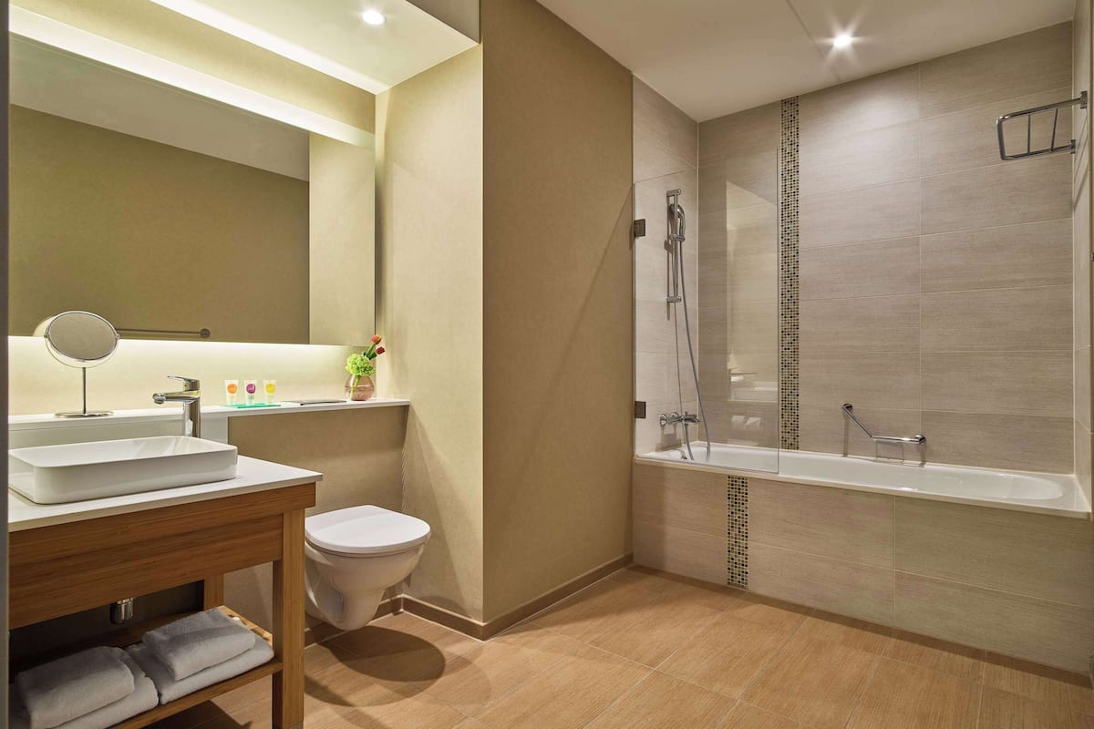 shower, designer toiletries, hair dryer, towels