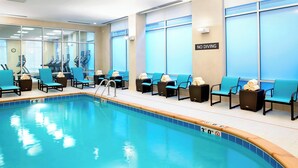 An indoor swimming pool with blue chairs and exercise equipment. - Residence Inn Secaucus Meadowlands (Secaucus)