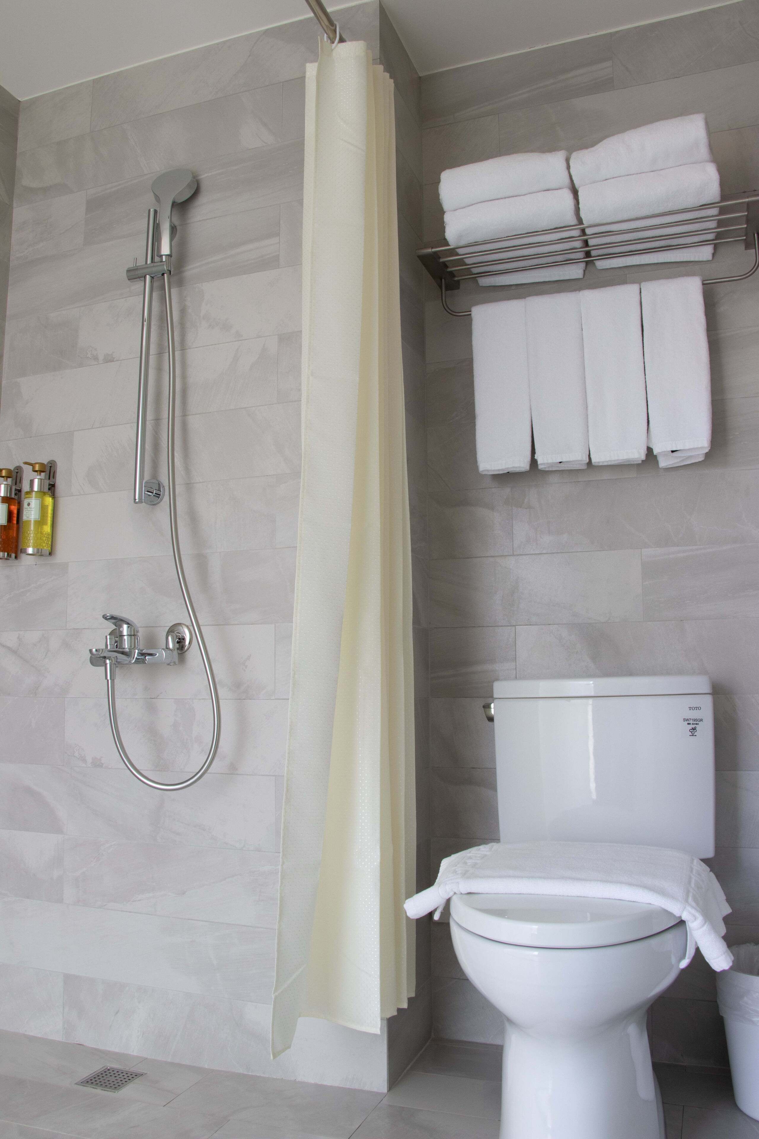 standard quadruple room | bathroom | shower, free toiletries, hair dryer, slippers