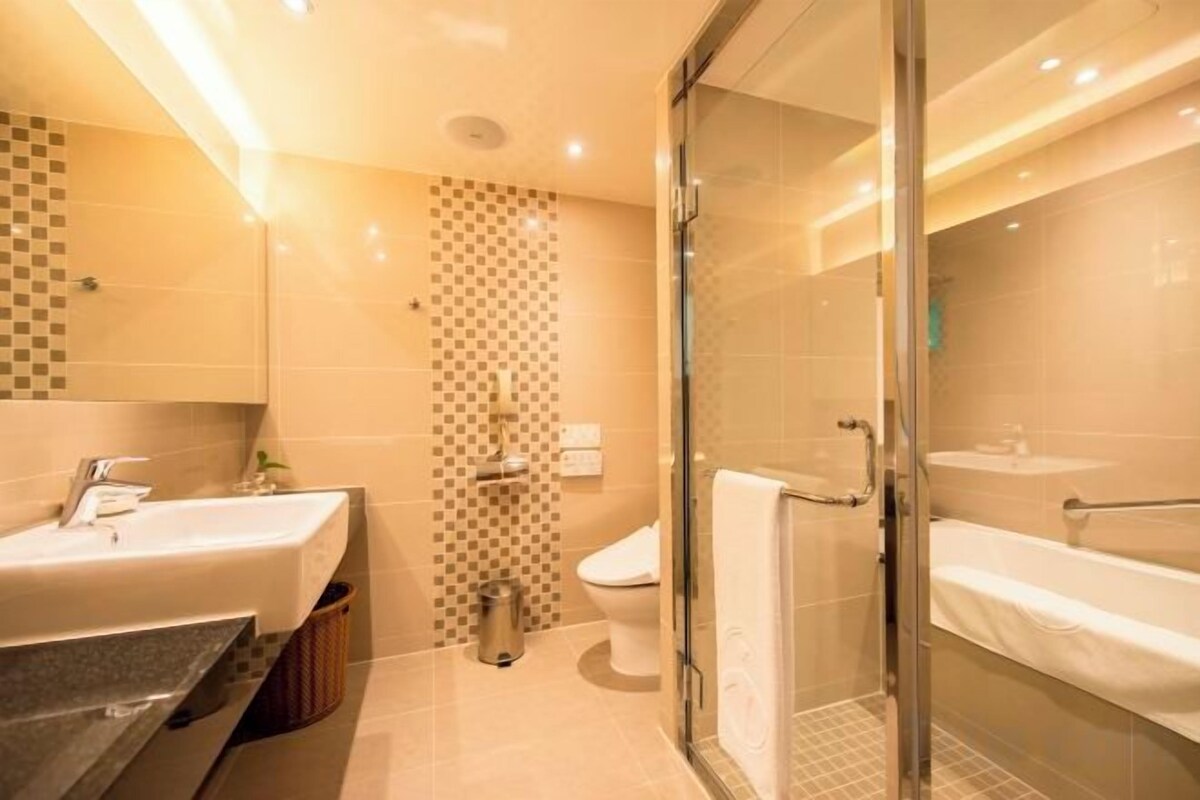 Separate tub and shower, hair dryer, slippers, towels