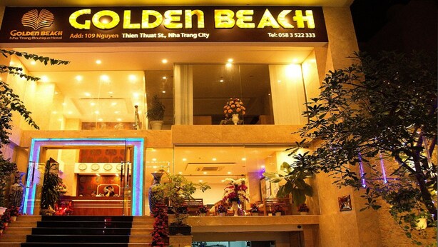 The exterior of the Golden Beach hotel with a signboard, entrance, and decorative plants. - Golden Beach Nha Trang Boutique Hotel (Nha Trang)