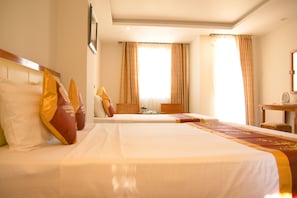 A hotel room with a large bed, a smaller bed, a desk, and a chair. - Golden Beach Nha Trang Boutique Hotel (Nha Trang)