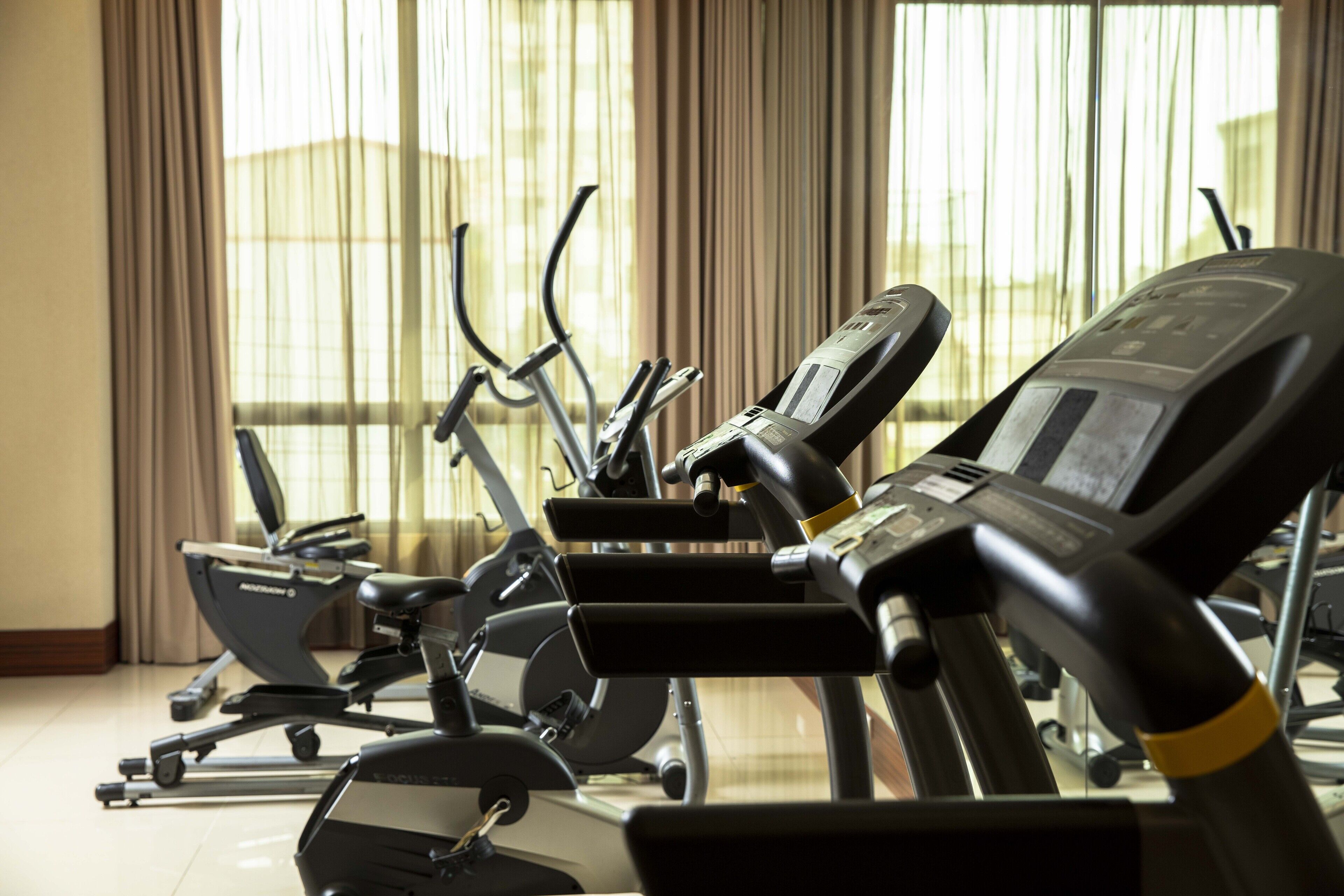 A gym with stationary bikes and treadmills.