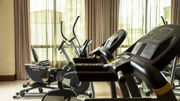 A gym with stationary bikes and treadmills.