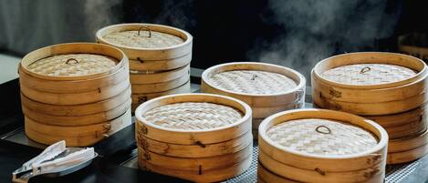Several bamboo steamers on a tray, likely used for cooking or serving food.