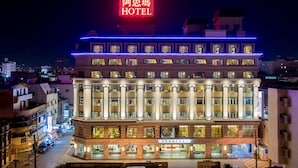 A multi-story hotel with a prominent neon sign, large windows, and a well-lit facade. - Arsma Hotel (Hualien City)