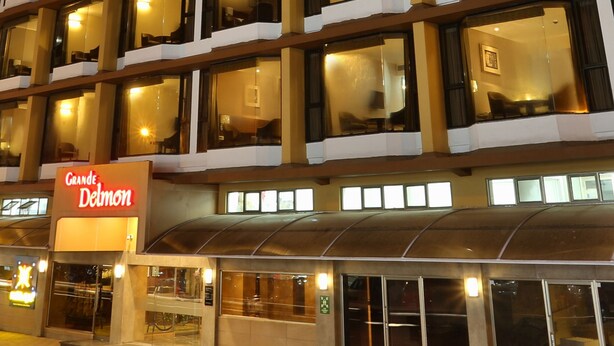 A multi-story hotel with illuminated windows and a sign reading "Grande Delmon." - Grande Delmon (Panaji)