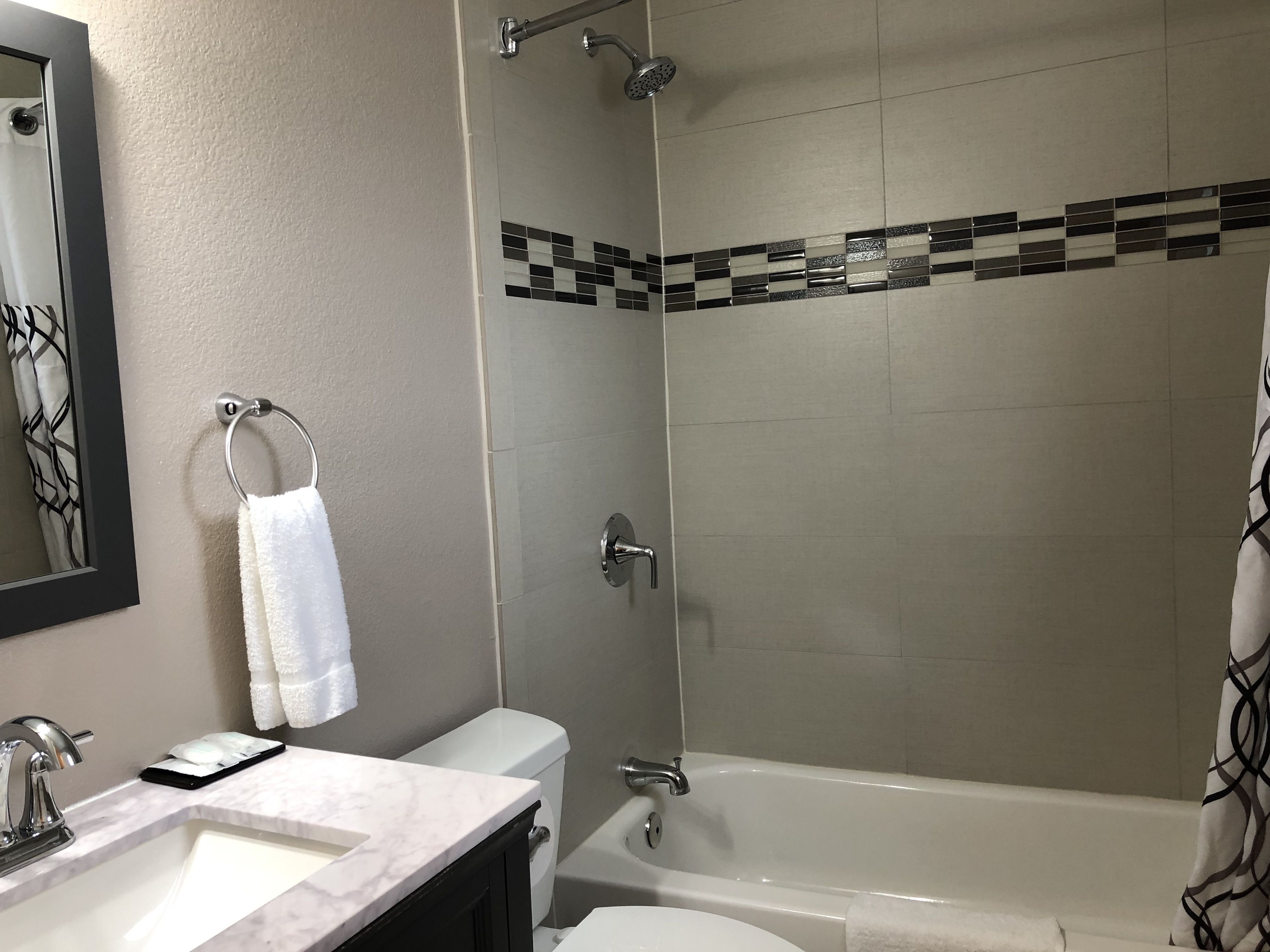 A bathroom with a sink, toilet, shower, and bathtub.