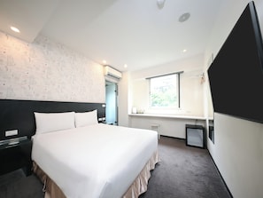 A hotel room with a large bed, a desk, a chair, a window, and an air conditioning unit. - CHECK inn Express Taipei YongKang (Taipei)