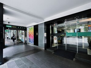 A modern hotel entrance with glass doors, a tiled floor, and signage for Checkinn Express. - CHECK inn Express Taipei YongKang (Taipei)